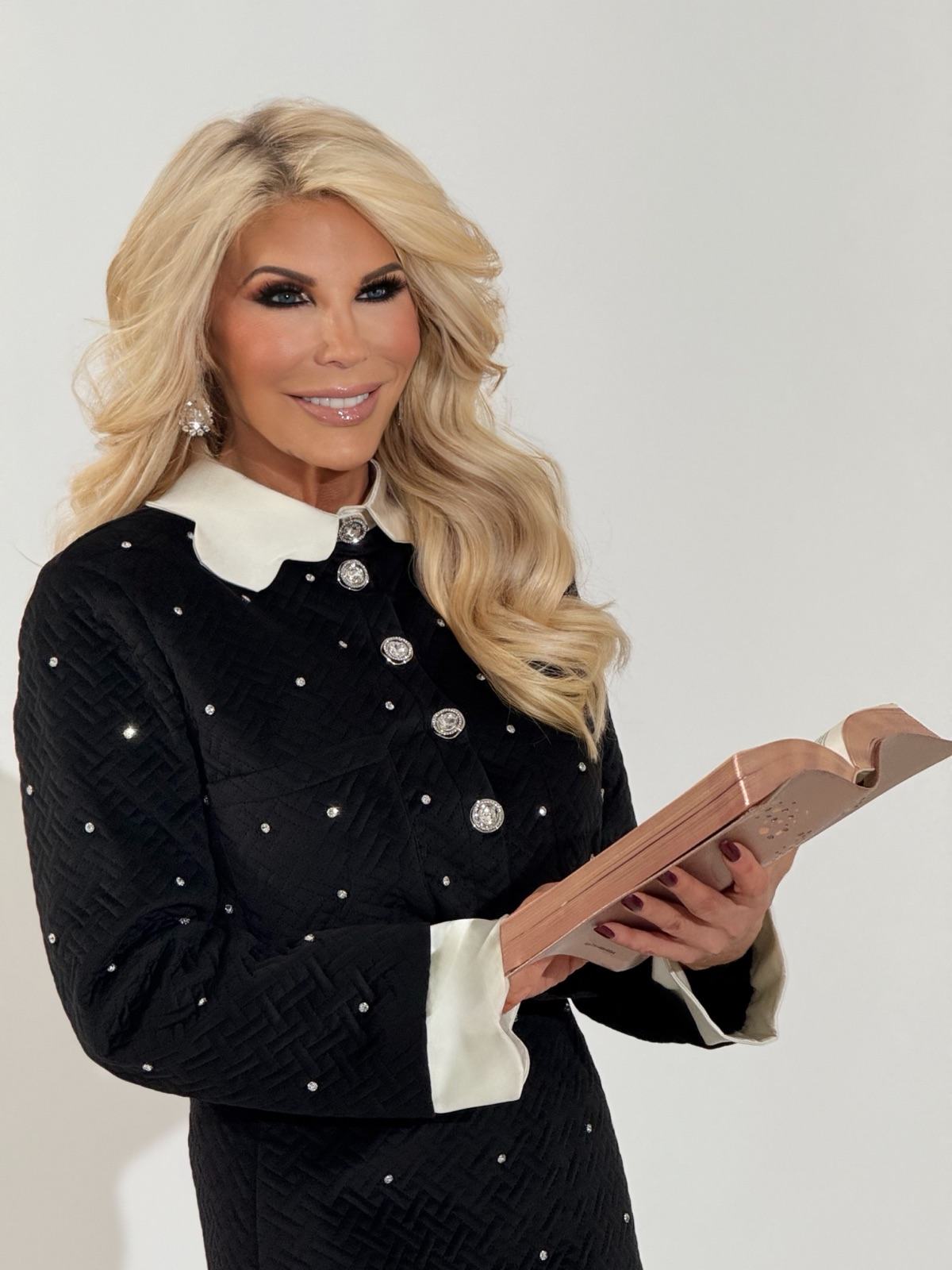 Dr. Tina Sarcevich holding an open Bible